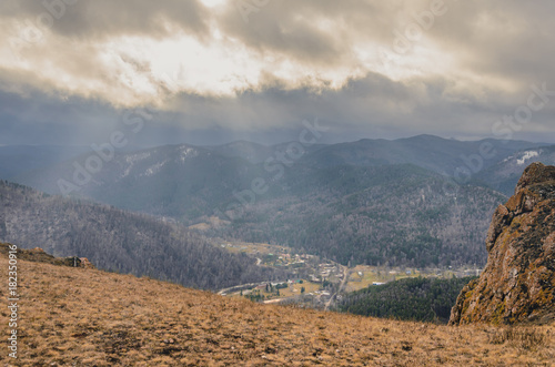 Autumn landscape - rocks and mountains, fog and clouds.