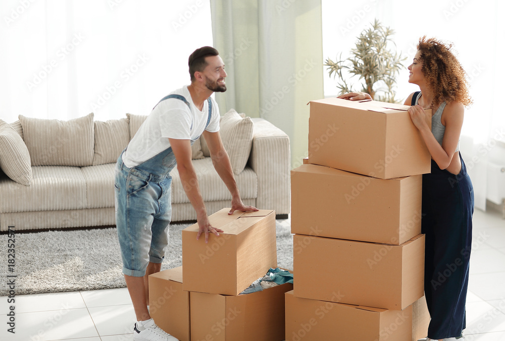 Happy and young couple looking at boxes Happy and young couple looking at boxes