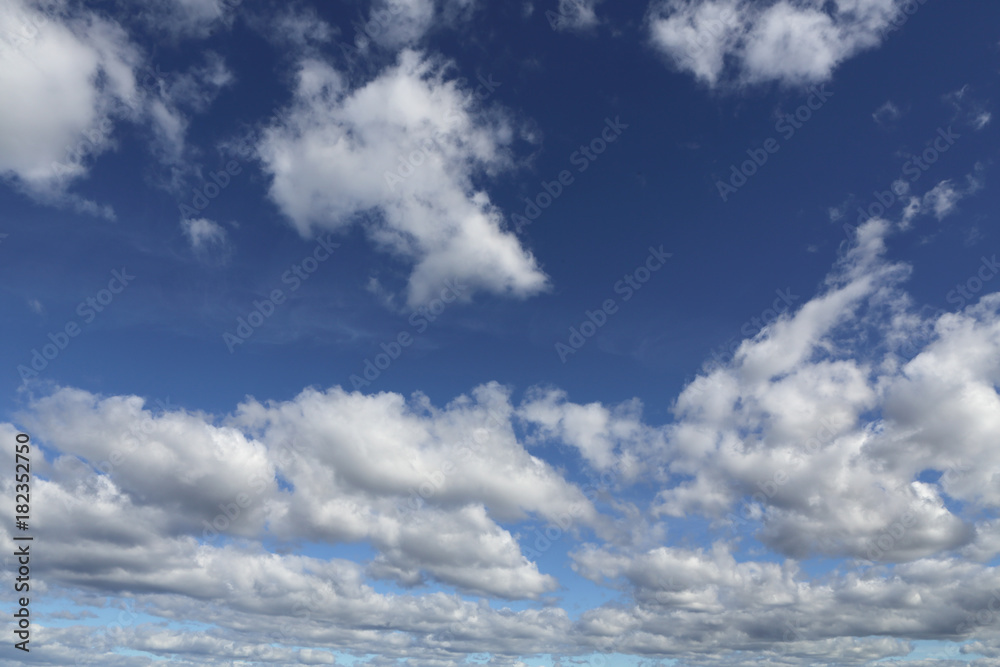 Blue skies with white puffy clouds