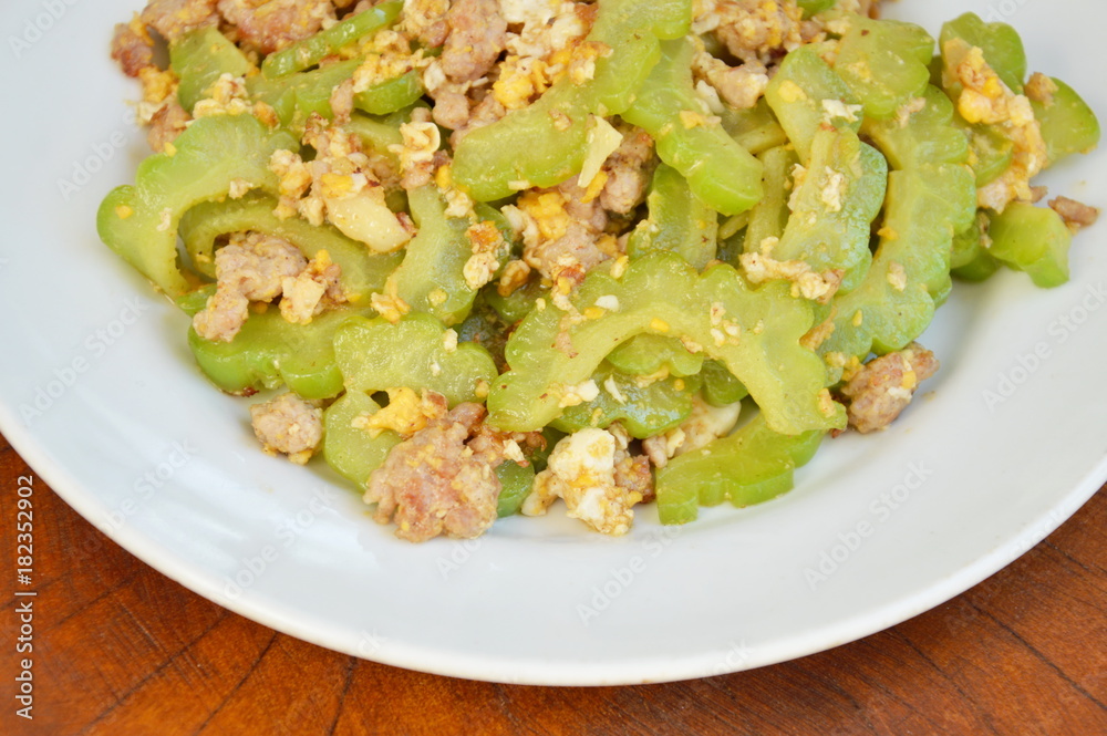 stir fried bitter cucumber with minced pork and egg on plate