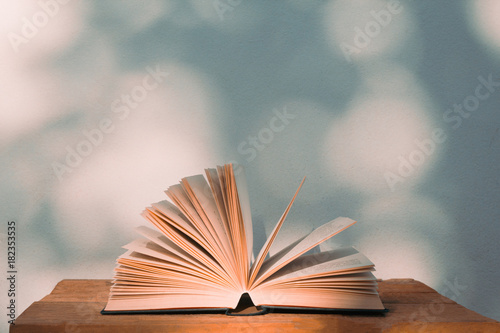 Education and Back to school concept with open book over bokeh wall background with text copy space