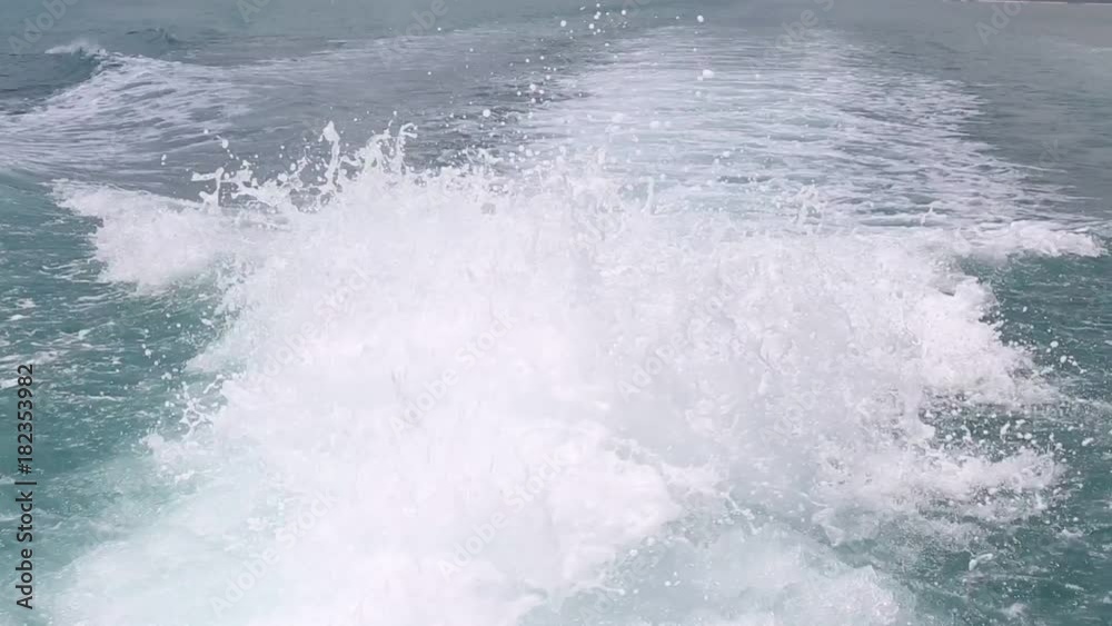 Blue ocean sea water wave with fast yacht boat wake foam of prop wash. Close up Blue ocean sea water wave with fast yacht boat wake foam of prop wash. Close up
