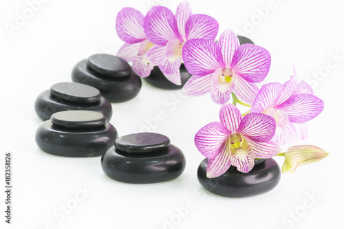 Spa concept with hot stones and orchid flowers 