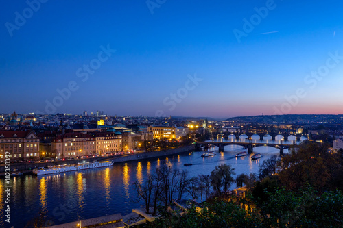 Panorama of the old part of Prague from the Letna park at dusk. Beautiful view on the bridges over the river Vltava at sunset. Old Town architecture, Czech Republic. © 1tomm