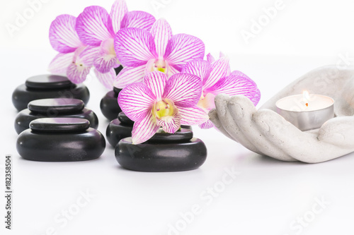 Spa concept with basalt stones and flowers close up