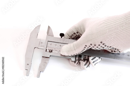 hand in a white glove holding a Vernier caliper for accurate measurement isolated on white background