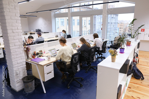 Office space in middle of working day with people immersed in wo