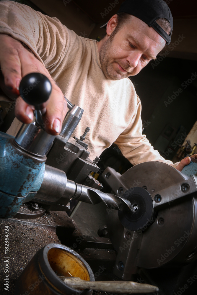 Fototapeta premium Metal worker working on lathe