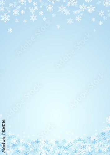 Festive vertical Christmas background and winter with copy space. snow and ice crystals on blue sky