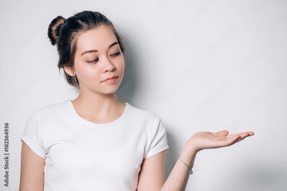Pretty cheerful woman gesturing with fingers and showing palm, Presenting your product. Expressive facial expressions Pretty cheerful woman gesturing with fingers and showing palm, Presenting your product. Expressive facial expressions