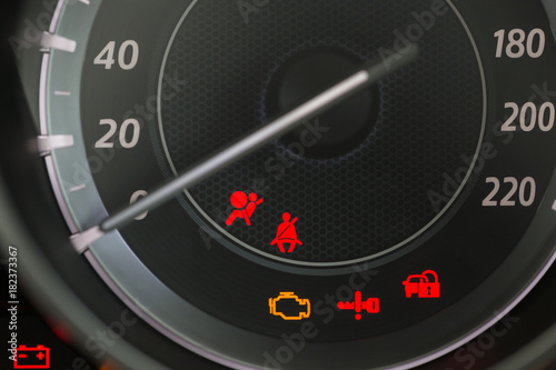Car Dashboard showing the seat belt warning light