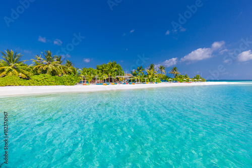 Beautiful beach scene in Maldives. Beach bar and blue sea and palm trees