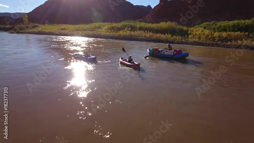 Aerial of family floating down the colorado river in dry desert