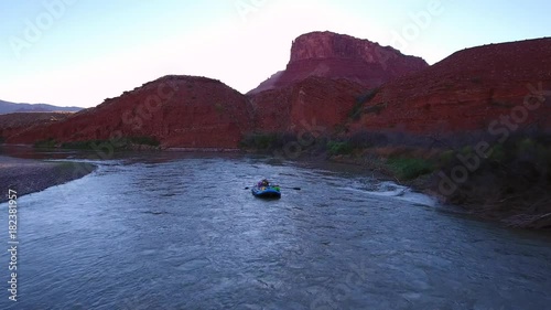 Aerial of man rafting down the beautiful desert colorado river in Utah
