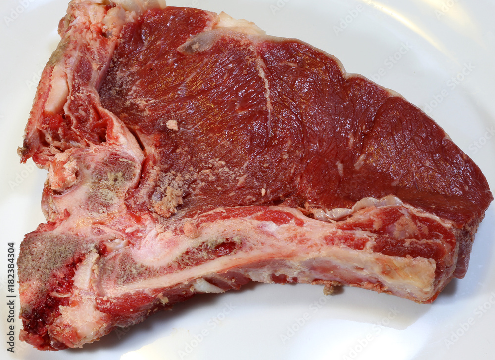 Fototapeta premium raw beef steak in ceramic dish