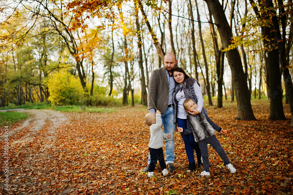 Happy caucasian family of mom dad and little girl with boy at majestic autumn fall forest. Happy caucasian family of mom dad and little girl with boy at majestic autumn fall forest.