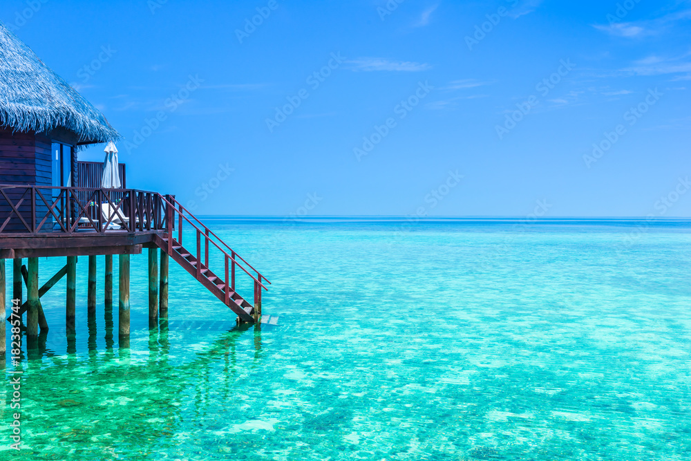 Overwater Bungalow. Overwater Bungalow in the lagoon turquoise water. Maldives, tropical island.