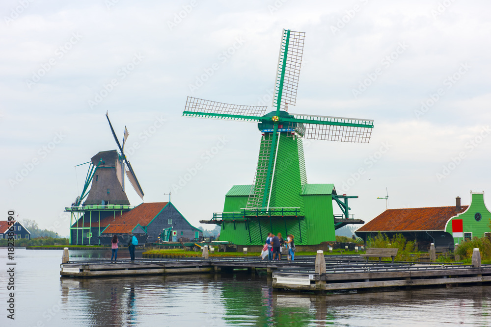 Windmills in Zaanse Schans. The Zaanse Schans is a typically Dutch small village in Amsterdam, Netherlands.. Windmills in Zaanse Schans. The Zaanse Schans is a typically Dutch small village in Amsterdam, Netherlands..