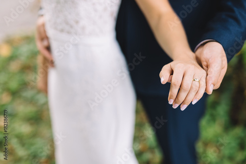 hand of bride and groom during wedding ceremony