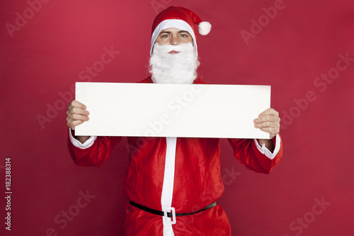 Santa Claus is holding an advertisement in front of him, © marcinmaslowski