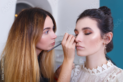 makeup artist applying eyeliner