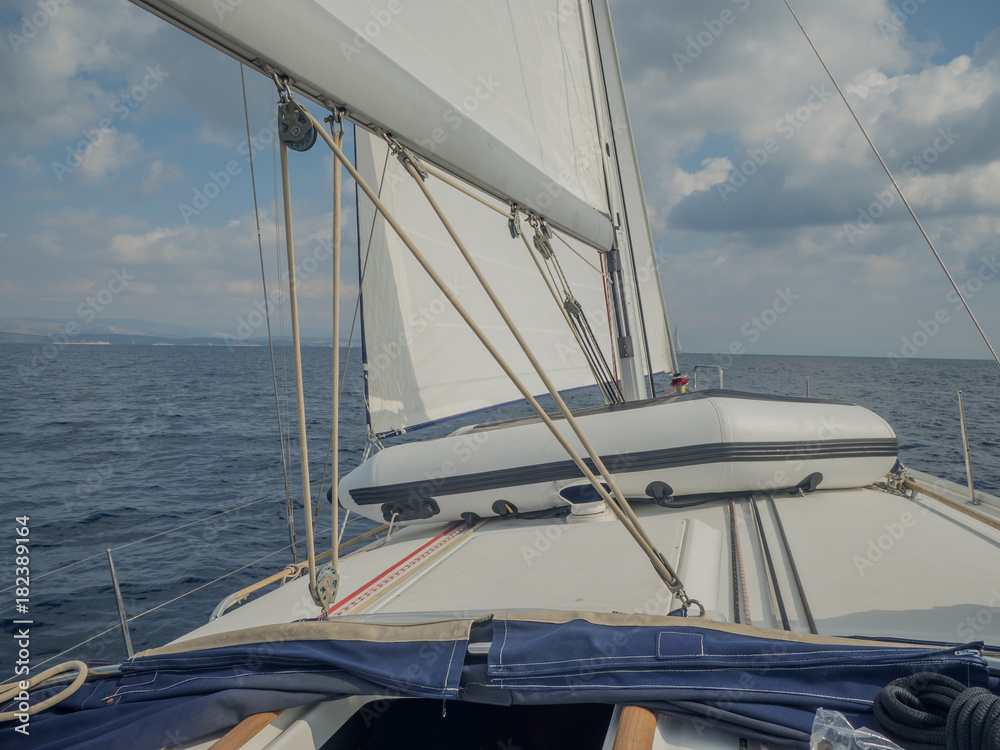 Obraz premium Byboat fixed on sailing boat sailing with open sails.