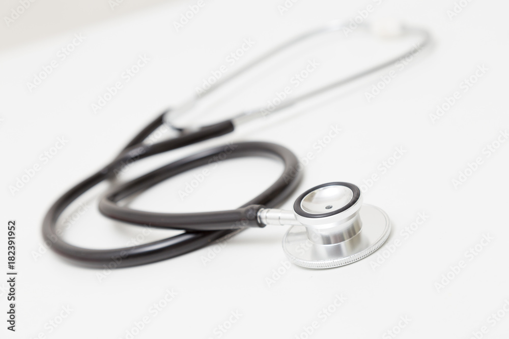Stethoscope on table. Isolated on white background. Studio lighting. Concept for healthy and medical Stethoscope on table. Isolated on white background. Studio lighting. Concept for healthy and medical