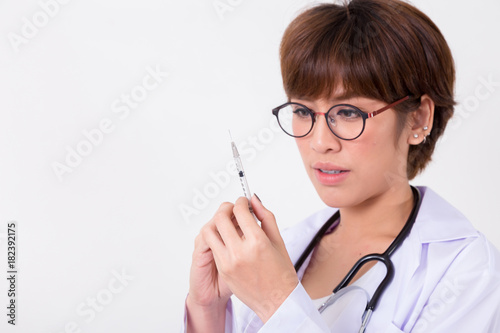 Doctor with syringe in hand. medical health professional holding a vaccine injection with fingers. Isolated on white background. Studio lighting. Concept for healthy