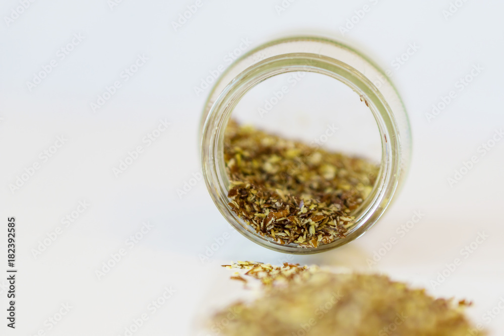 Close up of a jar of spattered flax seed. Concept health. Flush depth of focus. Close up of a jar of spattered flax seed. Concept health. Flush depth of focus.