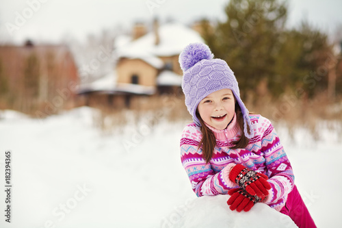 child building a snowman
