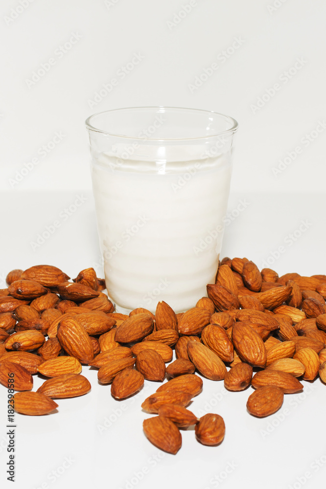 Glass of almond milkn on a white background Glass of almond milkn on a white background