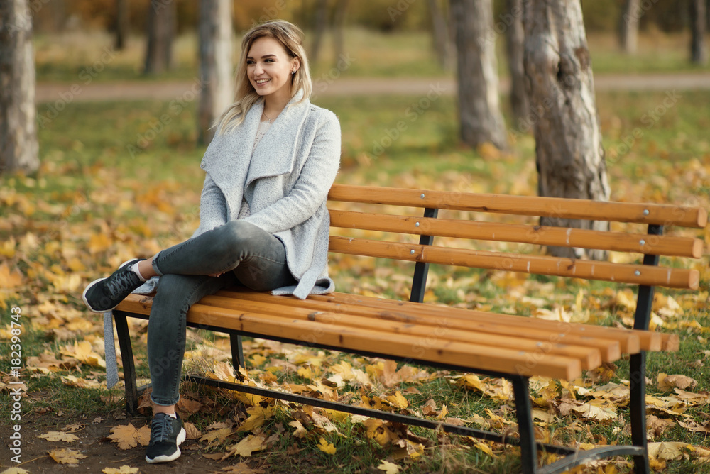 young beautiful woman in park. Autumn background young beautiful woman in park. Autumn background