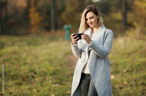 young beautiful woman in park. Autumn background 