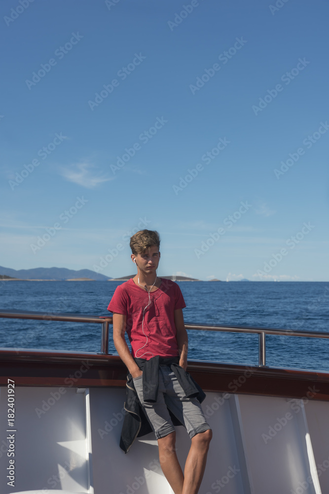 Fototapeta premium Teen boy traveling on the Adriatic Sea with cruise ship