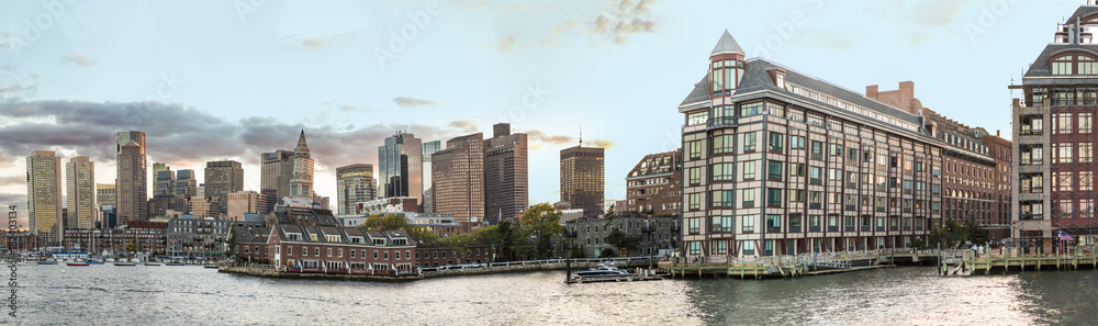 view to  skyline of Boston with old and modern skyscraper and river with boats.