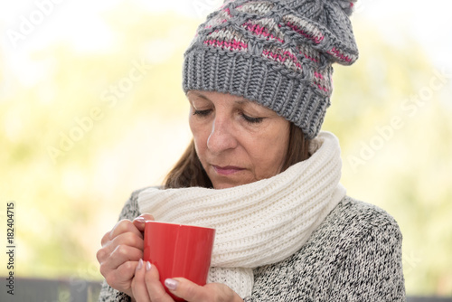 Mature woman drinking hot beverage © thodonal