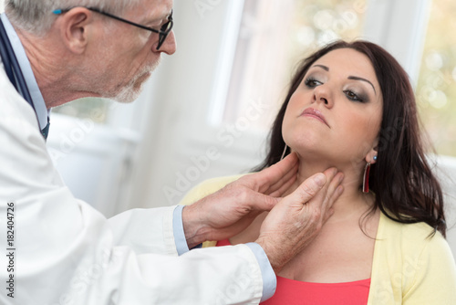 Doctor checking thyroid