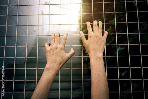 Inside view - Hands of the prisoner in jail