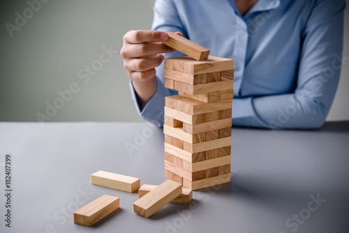 Close up Woman hand arranging wood block stacking as step stair. Business concept growth success process.