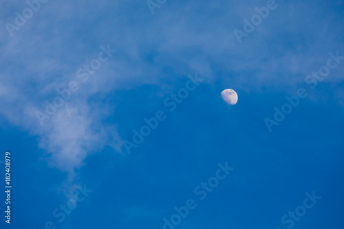Half moon on blue sky and cloud