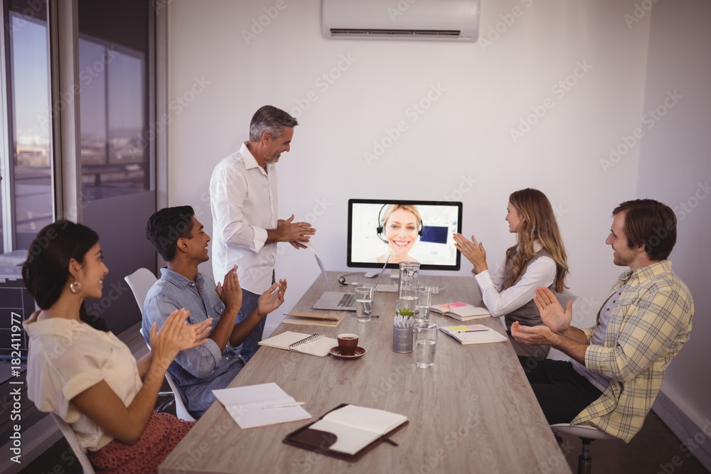 Business people attending video conference in office Business people attending video conference in office