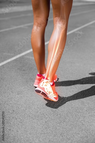 Low section of female athlete walking on sports track