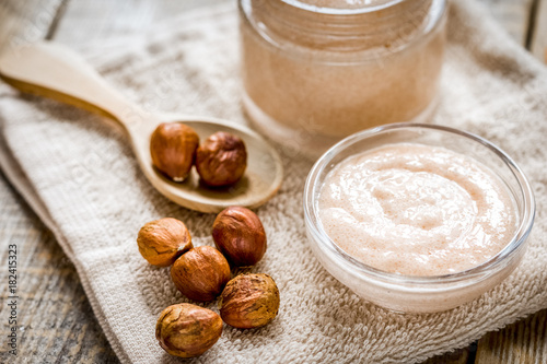 natural scrub with hazelnut on wooden table background
