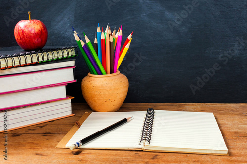 Back to school. Stack of book and color pencil pot on wooden table with copy space. Education concept.