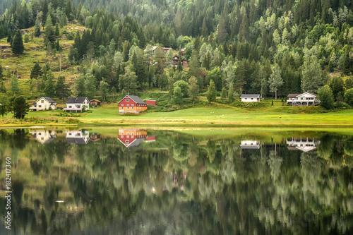 beautiful mountain houses and lakes in Norway with reflection © nedomacki