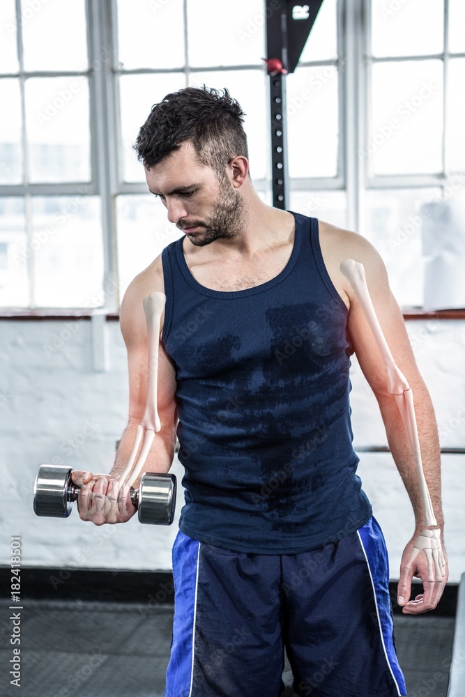 Highlighted arm of strong man lifting weights at gym Highlighted arm of strong man lifting weights at gym