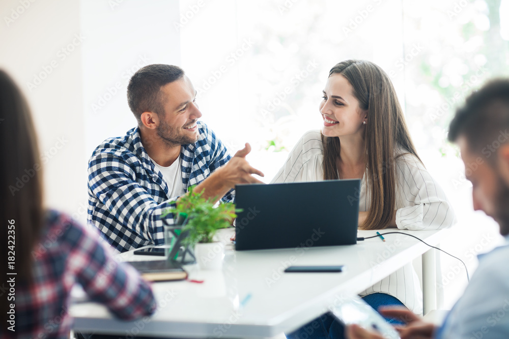 Smiling business people sharing their ideas in modern office Smiling business people sharing their ideas in modern office