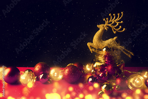 golden glitter reindeer with bokeh and decor ball in christmas concept