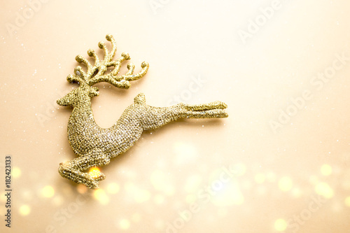 golden glitter reindeer with bokeh in christmas concept