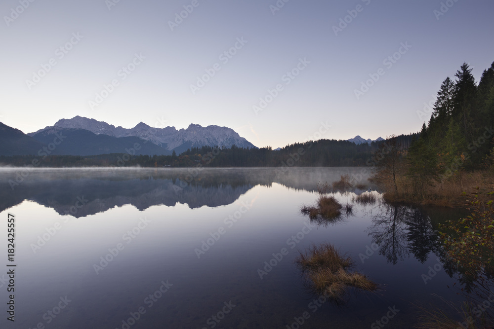 Morning mist, view over lake Barmsee to the Karwendel mountains, near Mittenwald, Bavaria, Germany Morning mist, view over lake Barmsee to the Karwendel mountains, near Mittenwald, Bavaria, Germany